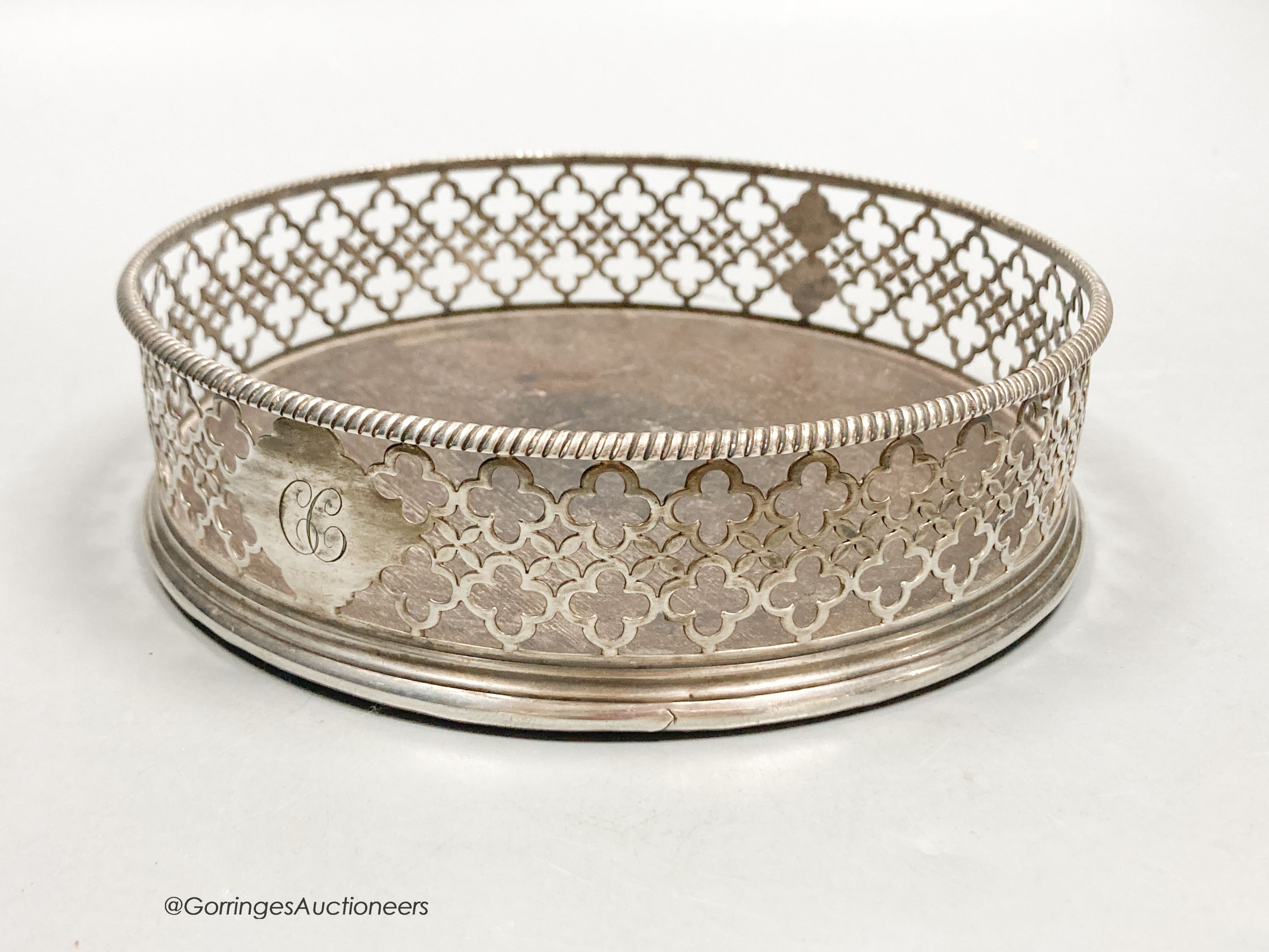 A George III pierced silver mounted wine coaster, Edward Lowe, London, 1775, with engraved initial, diameter 14.2cm.